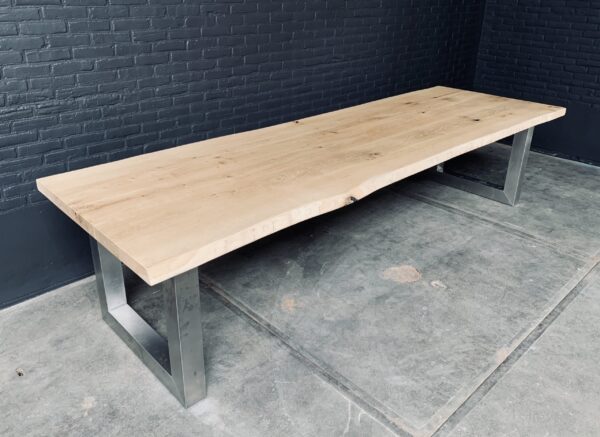 Unique heavy oak table with stainless steel base.