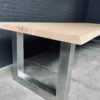 Unique heavy oak table with stainless steel base.