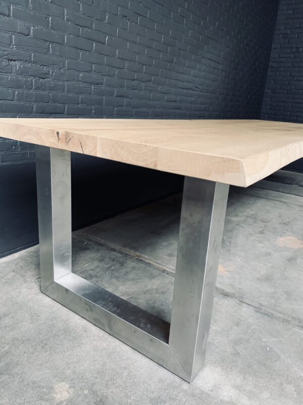 Unique heavy oak table with stainless steel base.