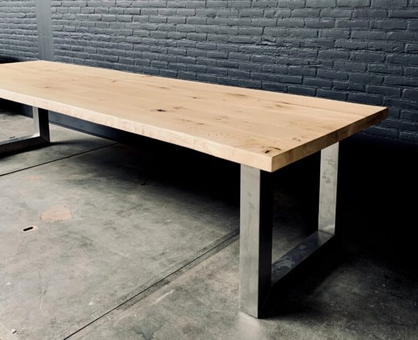Unique heavy oak table with stainless steel base.