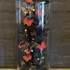 Antique bell jar filled with a mix of black / red butterflies