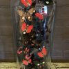 Antique bell jar filled with a mix of black / red butterflies