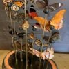 Antique oval bell jar filled with colorful butterflies