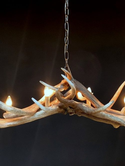 Heavy antler chandelier  with 6-lights and 2 spots.