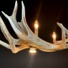 Heavy antler chandelier  with 6-lights and 2 spots.