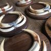 Teeth of warthogs that are mounted on unique solid oak planks.