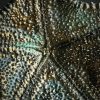 Gemetalliseerde zeester op marmeren sokkel Gemetalliseerde zeester op marmeren sokkel